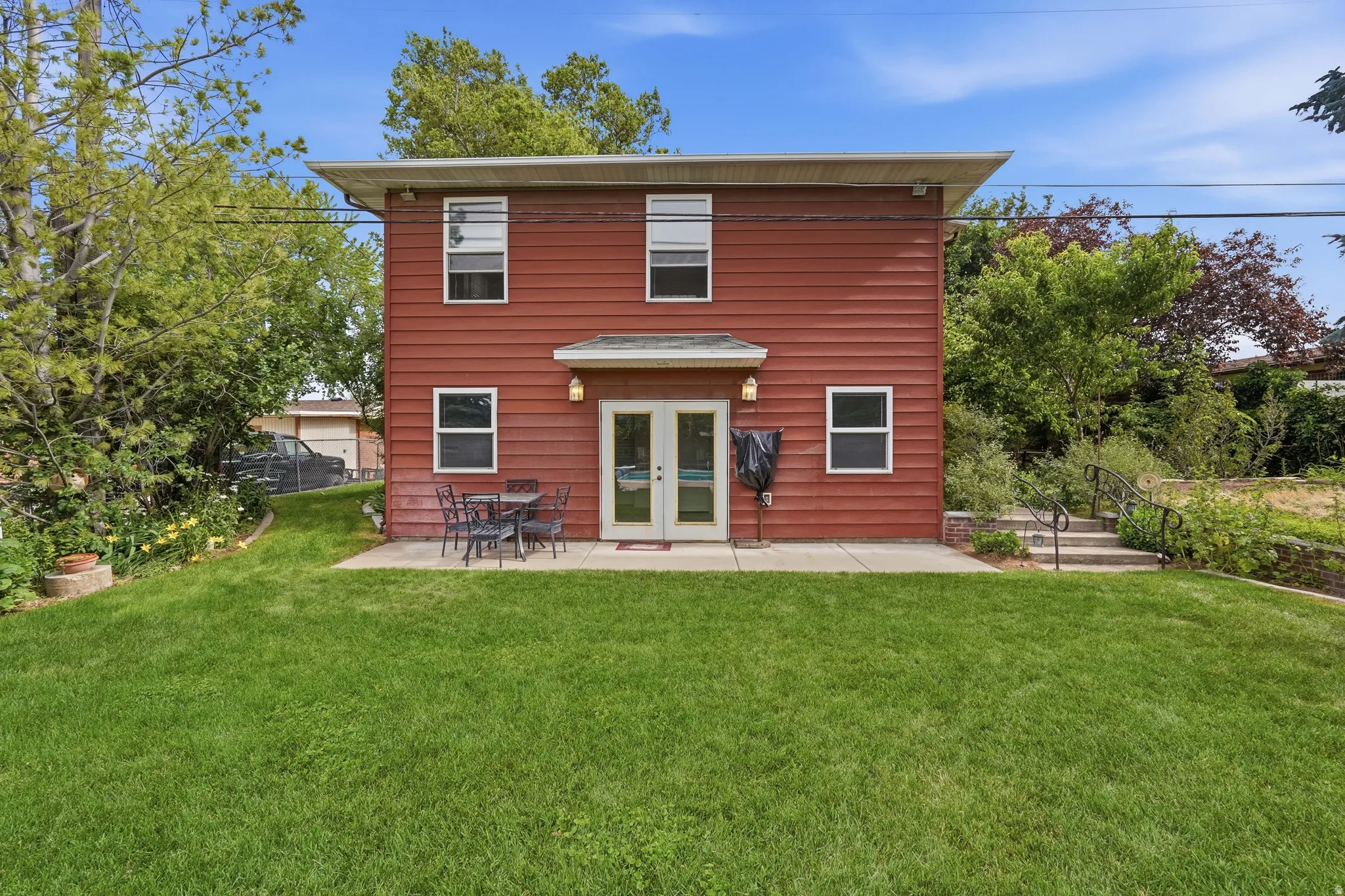 Two-story residence with red siding and multiple windows
