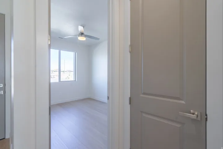 Corridor with light wood-style floors and baseboards