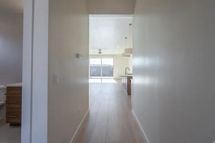 Corridor with baseboards and light wood-type flooring
