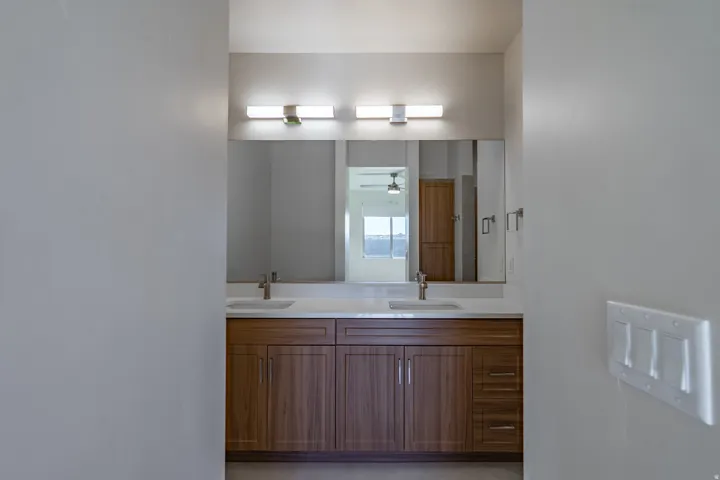 Bathroom featuring double vanity and ceiling fan