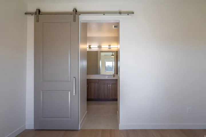 Hallway featuring a barn door and light wood-style floors