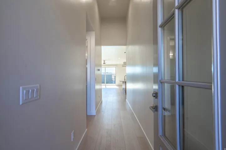 Hallway with baseboards and light wood finished floors