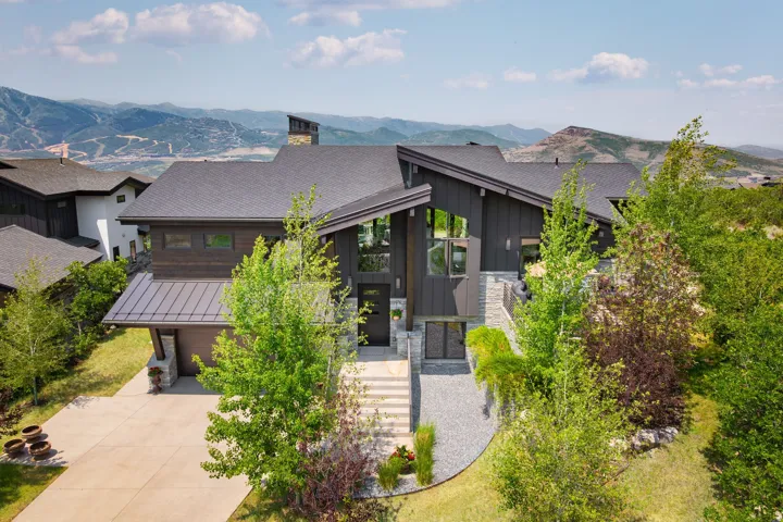 Contemporary exterior with dark siding and stone accents