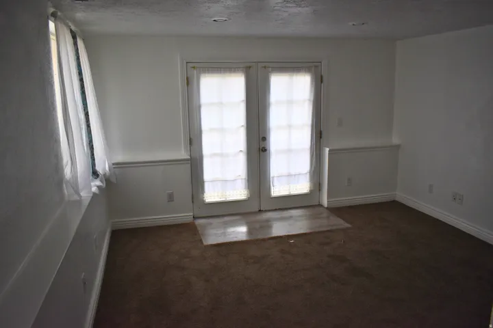 Bright interior space with French doors, recessed lighting, and a window for natural light