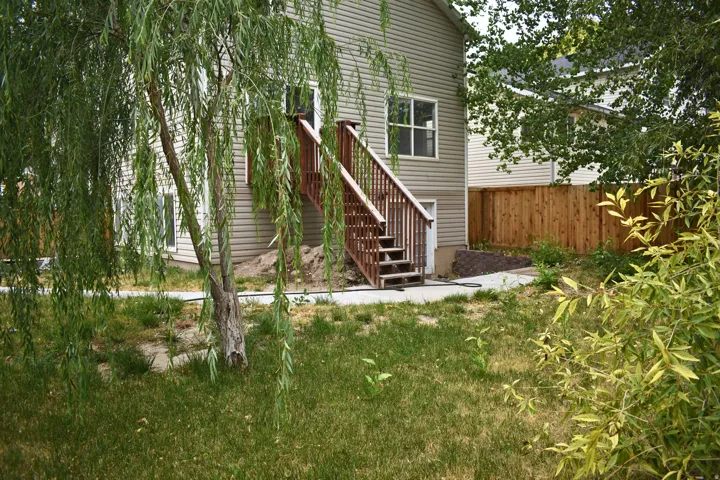 Rear exterior of the property featuring horizontal siding and a two-story wooden deck with stairs