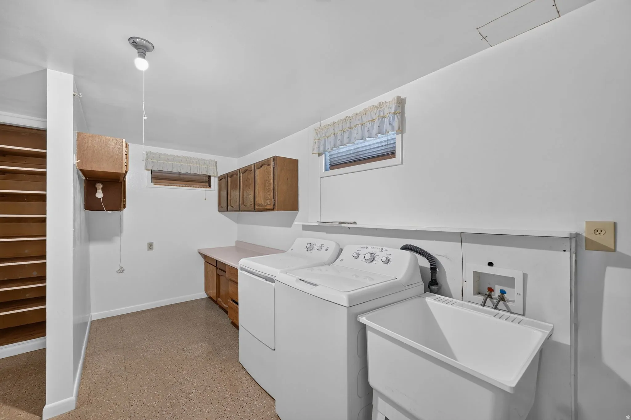 Dedicated laundry area featuring a utility sink and appliances