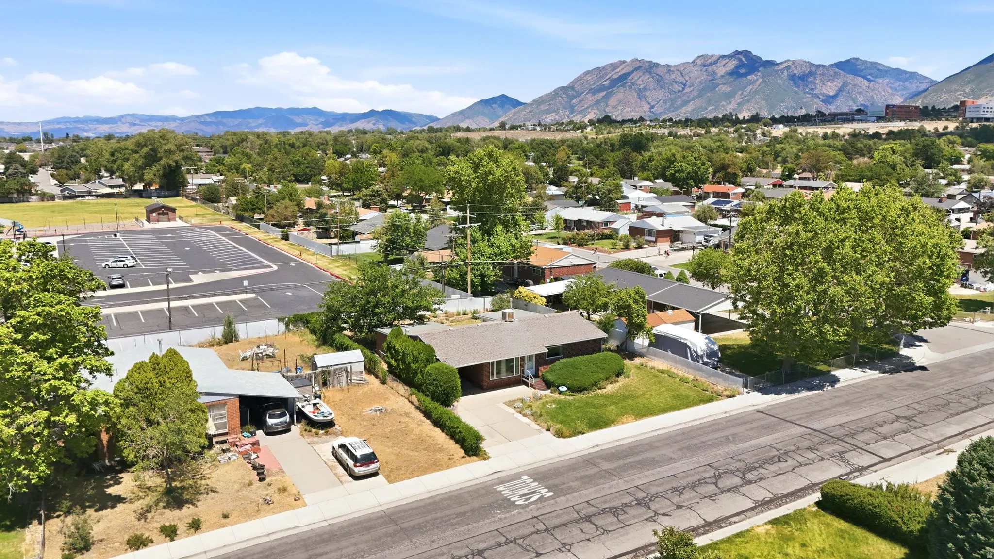 Single-story residence with a front lawn and paved driveway