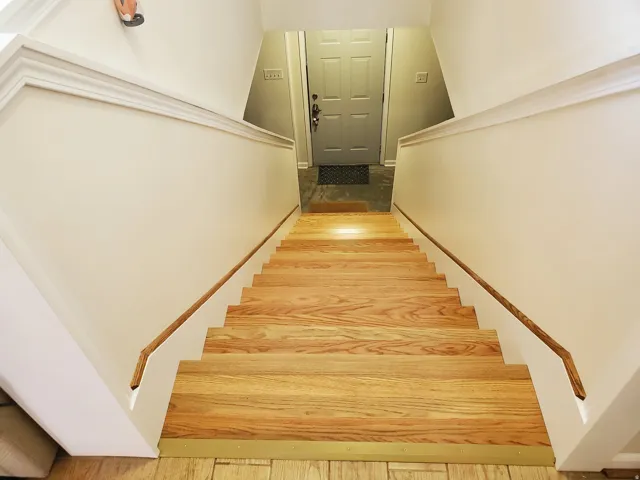 Hardwood staircase with natural wood treads and white risers