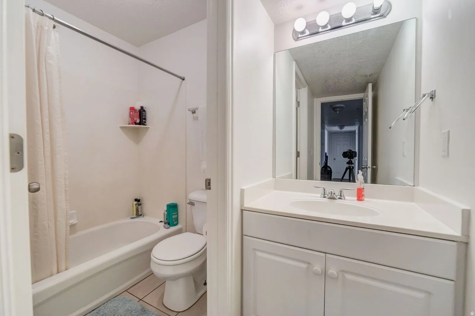 White vanity with an integrated sink and white cabinetry