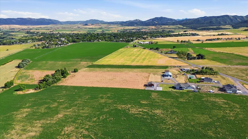 Expansive agricultural landscape with varied crop fields and distant mountains