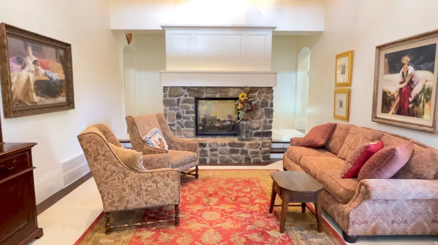 Stone fireplace with a white mantel and surround