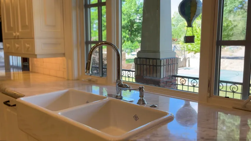 Dual basin farmhouse sink with polished chrome faucet