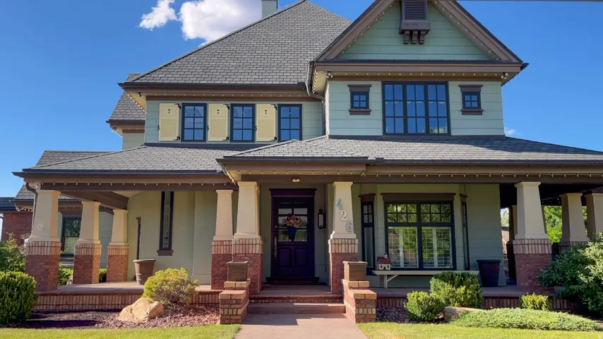 Distinctive exterior featuring a covered porch with substantial columns, brick accents, and a multi-gabled roofline