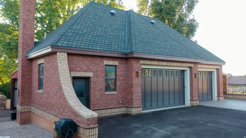 Brick exterior with a dark shingle roof and a prominent brick chimney