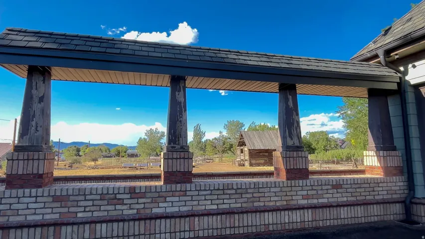 Covered walkway with brick base and distressed wood columns