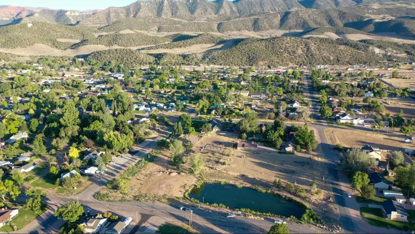 Expansive aerial panorama showcasing a residential landscape set against a mountainous backdrop