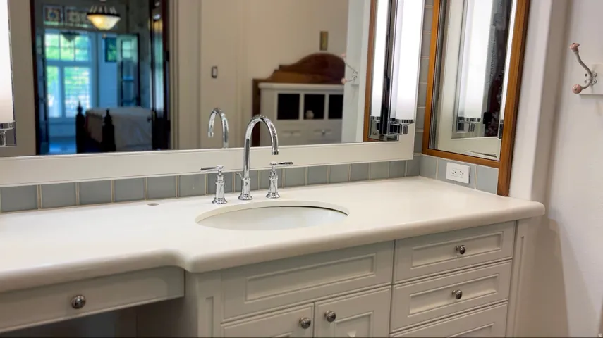 Integrated vanity with an undermount sink and chrome hardware