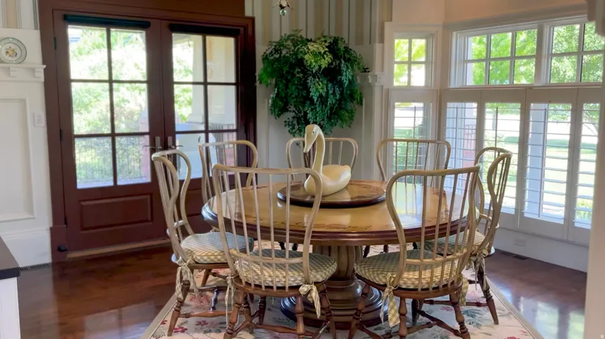 Bright dining area featuring rich wood-finish flooring