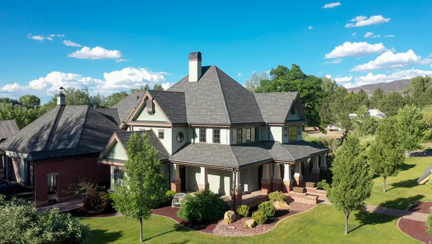 Craftsman-style residence featuring a multi-gabled roofline and a stone and stucco facade
