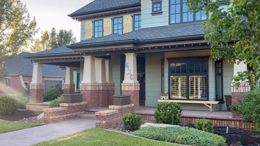 Inviting covered front porch with brick column bases and a built-in bench