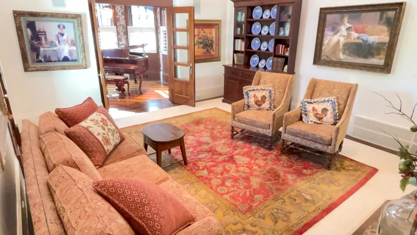 Light-filled interior featuring hardwood flooring, a built-in display cabinet, and French doors