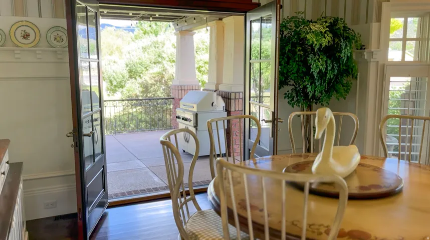 Dining area with rich wood-finish flooring and a direct opening to an outdoor patio