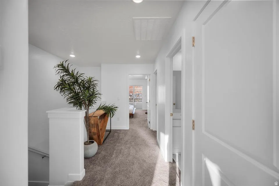 Hallway featuring plush carpeting and recessed lighting