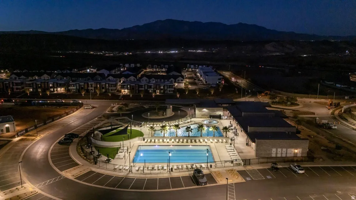 Community recreation area featuring multiple pools, spa, and mature palm trees