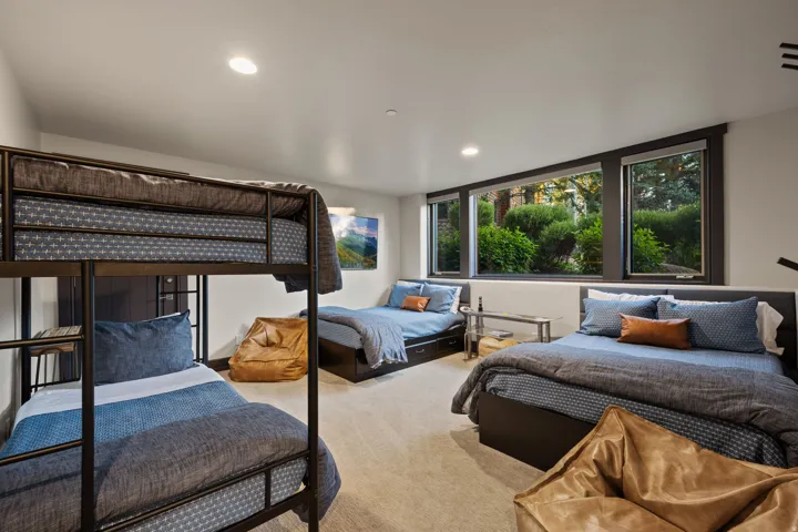 Spacious room featuring a large window array, recessed lighting, and soft carpeting
