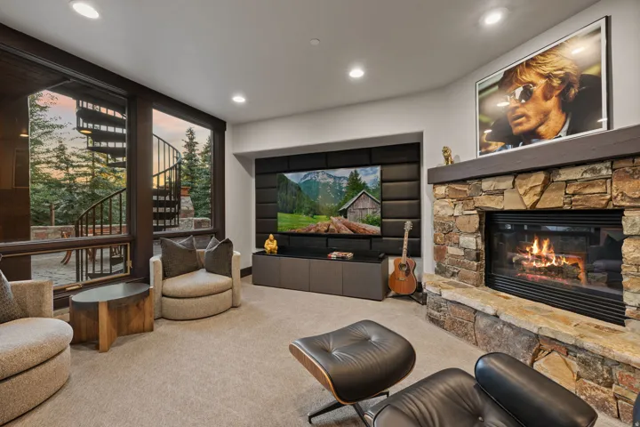 Stone-clad fireplace with a wood mantel