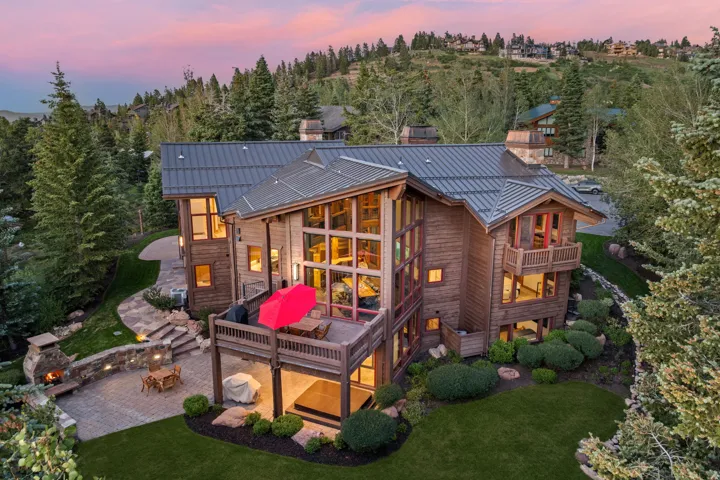 Contemporary mountain residence with a multi-level design, featuring natural wood siding and a metal roof