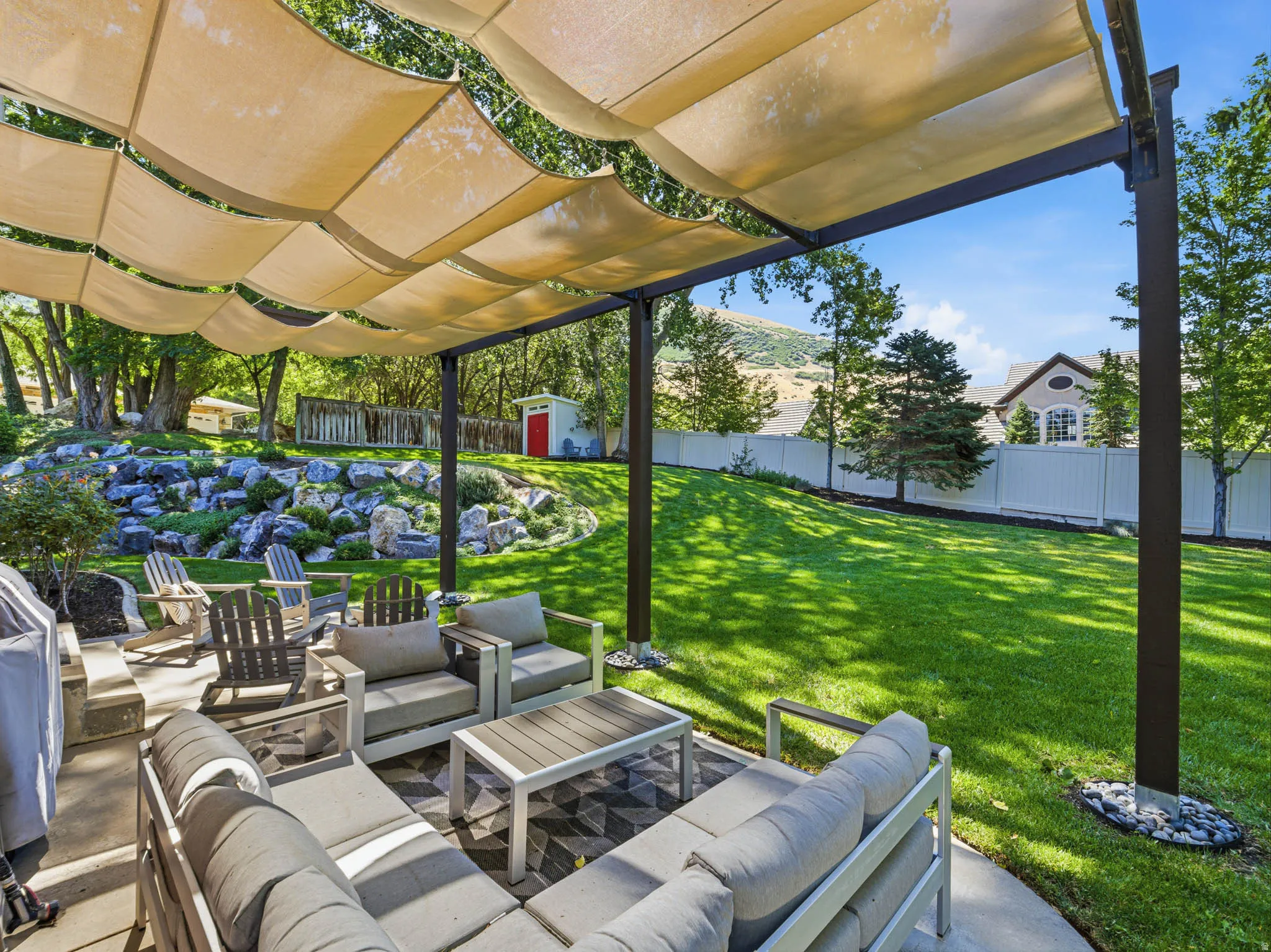 Patio with a pergola featuring a retractable fabric canopy