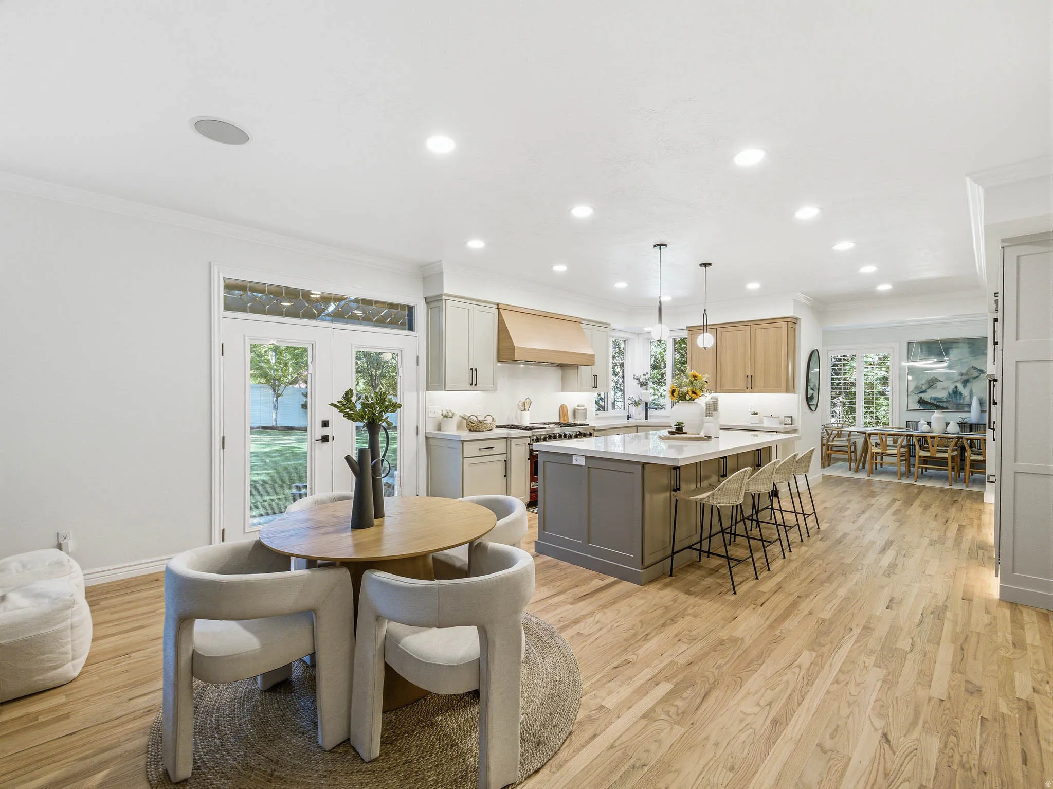 Open-concept kitchen and dining area featuring light wood-finish flooring