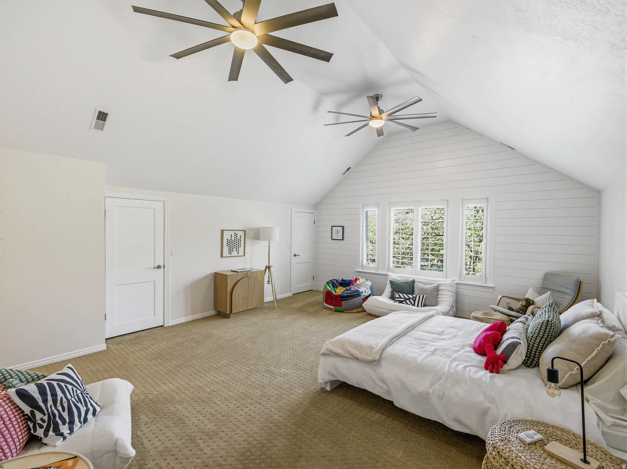 Spacious room featuring vaulted shiplap ceilings and recessed lighting