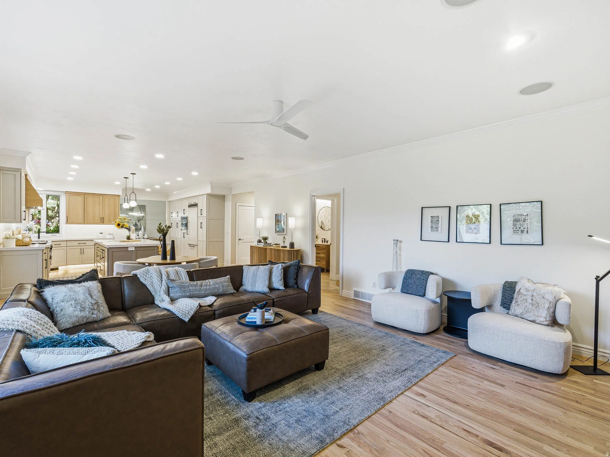 Spacious living area featuring wood flooring, recessed lighting, and a contemporary ceiling fan