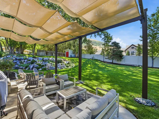 Patio with a pergola featuring a retractable fabric canopy