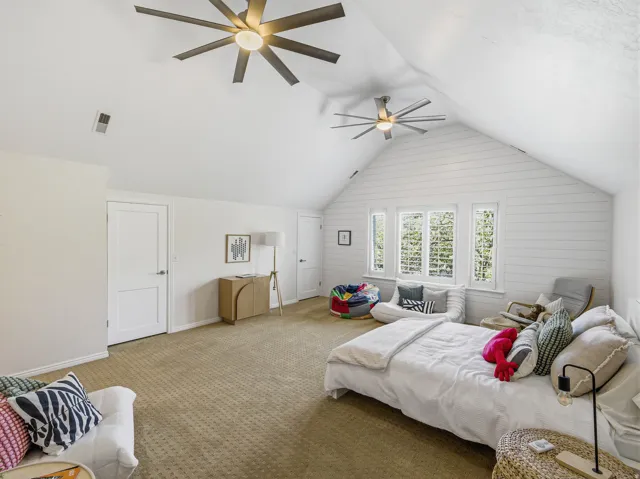 Spacious room featuring vaulted shiplap ceilings and recessed lighting