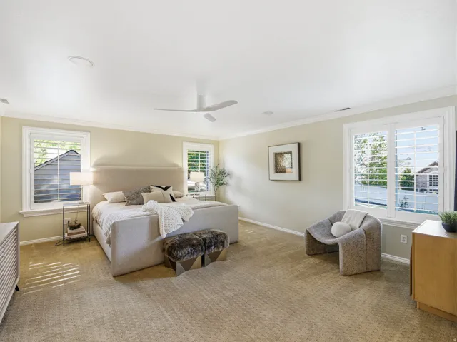 Spacious room featuring neutral carpeting, light-colored walls, and crown molding