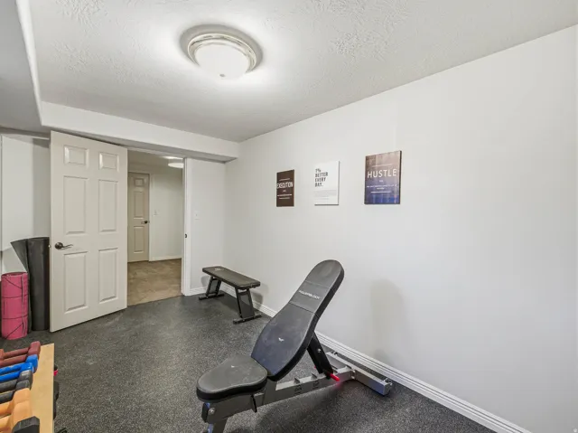 Recreational space featuring durable dark flooring and a neutral wall palette