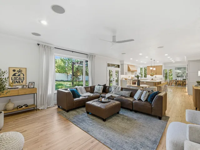 Open-concept living space featuring wood-finish flooring and recessed lighting