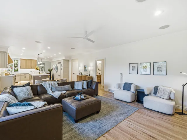 Spacious living area featuring wood flooring, recessed lighting, and a contemporary ceiling fan