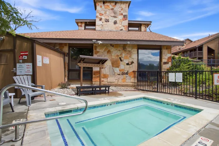 Outdoor spa with concrete decking and metal handrails