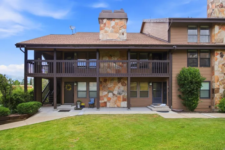 Multi-level exterior featuring stone accents and wood siding