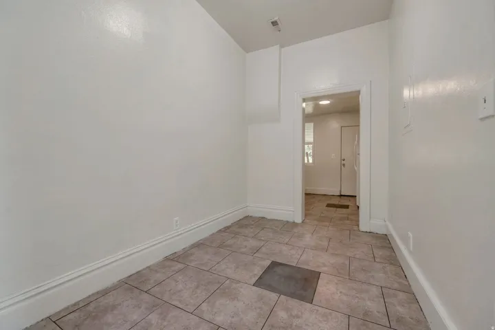 Neutral-toned rectangular tile flooring with a contrasting square insert