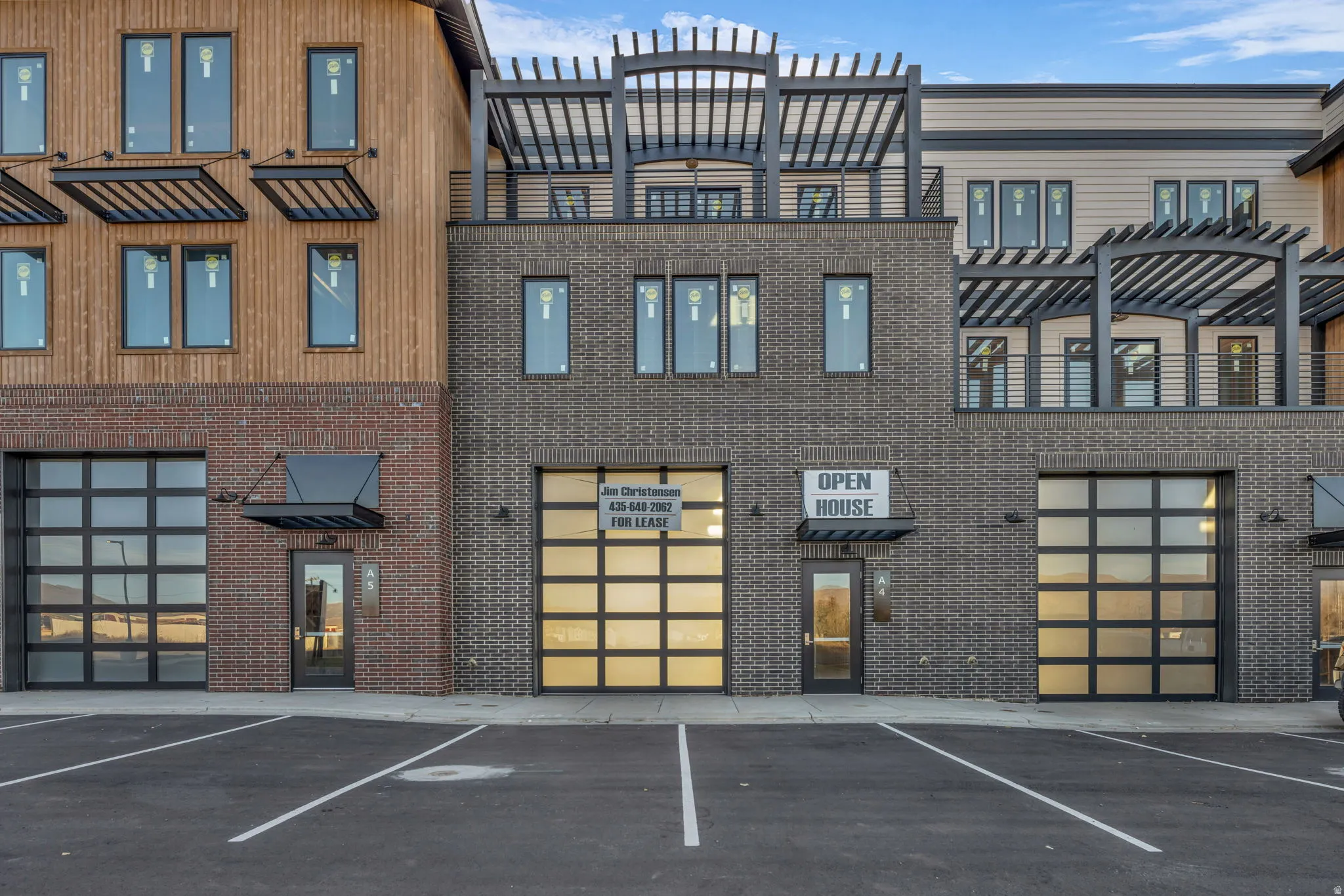 Modern commercial facade featuring dark brick and natural wood-finish siding