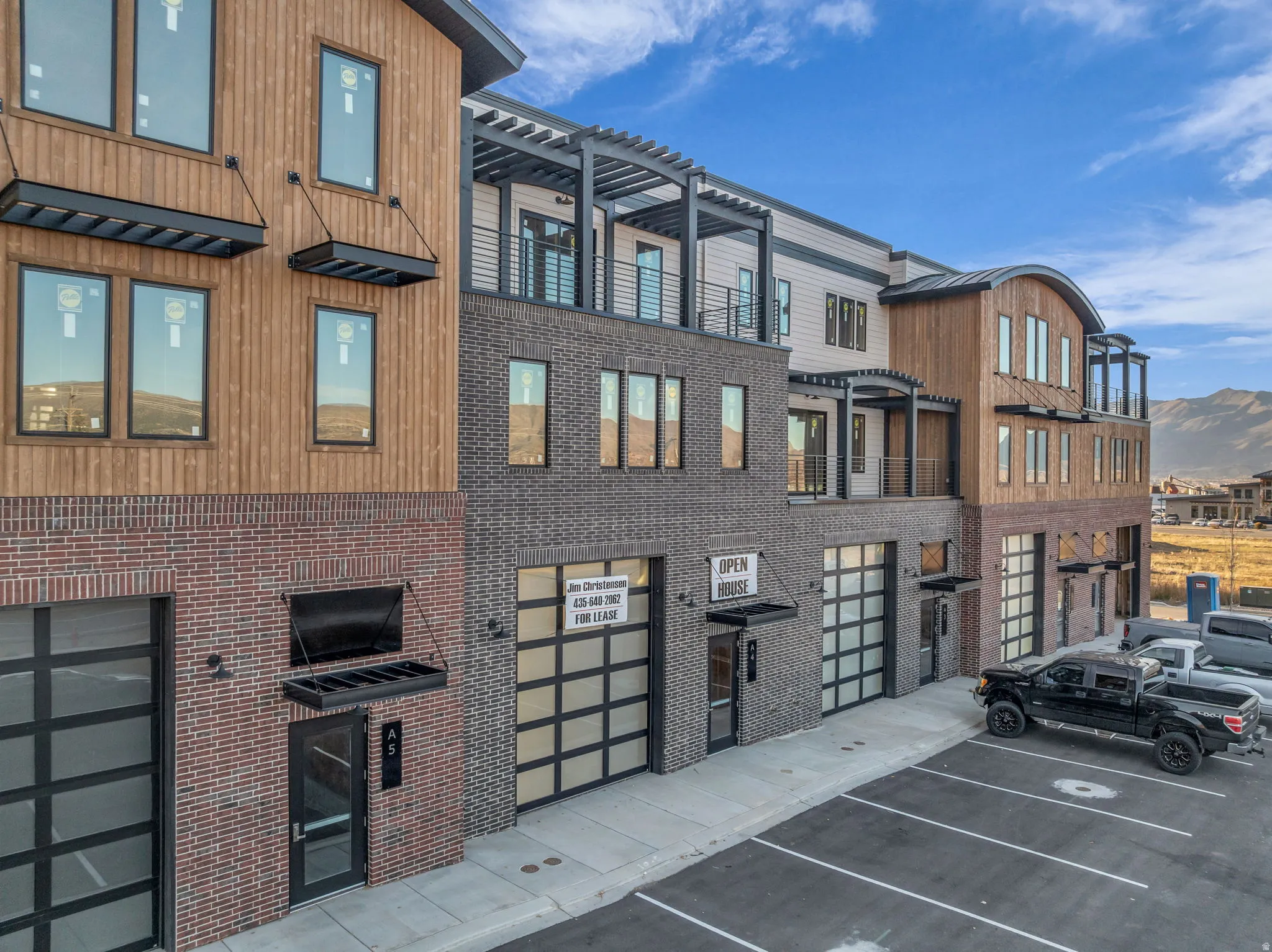 Modern multi-story building featuring brick, wood-panel, and siding exteriors