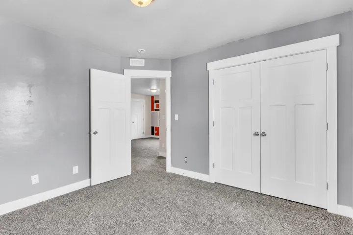 Interior room featuring gray wall paint and gray carpet flooring