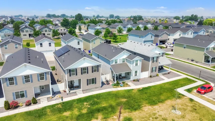 Aerial perspective showcasing a residential development with multiple two-story homes featuring varying siding colors and rooflines