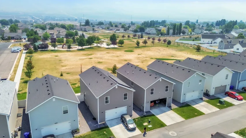 Aerial perspective showcasing a row of residential properties with gabled roofs and attached garages