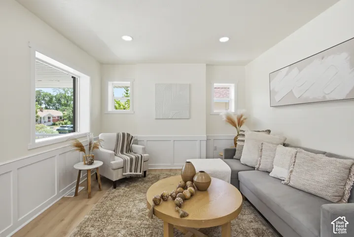 Living area featuring light wood-finish flooring and recessed lighting